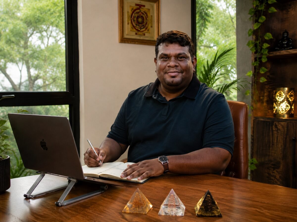 Raghavendra Hebbur, Vastu consultant, at his desk with his notebook and laptop